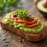 Harissa Avocado Toast with creamy avocado, spicy harissa, and fresh toppings on toasted sourdough bread.