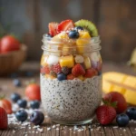 Creamy chia pudding with seasonal fruits like strawberries, mango, and blueberries, topped with coconut flakes and chia seeds – an easy healthy breakfast recipe